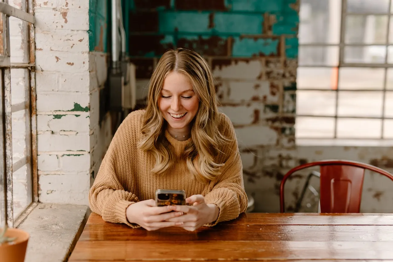 Creator at a cafe using a phone