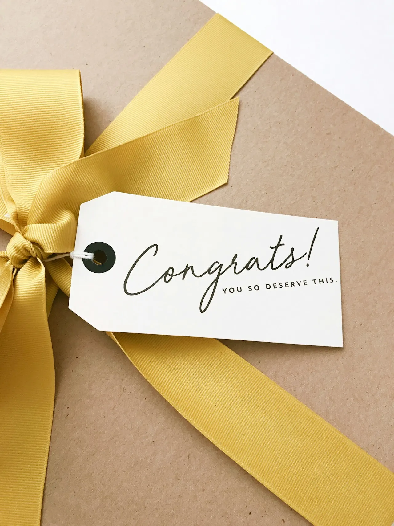 A congratulations card beside a wrapped gift